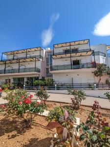 a building with balconies and plants in front of it at Kalliopi Studios - Apartments in Kato Daratso