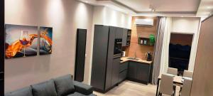 a living room with a couch and a kitchen at A&A Luxury Apartments Preveza in Preveza +5 photos