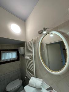 a bathroom with a mirror and a toilet and a sink at ANTICA DIMORA DEL BORGO Luxury TUSCANY in Bibbiena