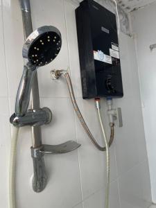 a hair dryer and a phone on a wall at Sky Space Bến Thành in Ho Chi Minh City