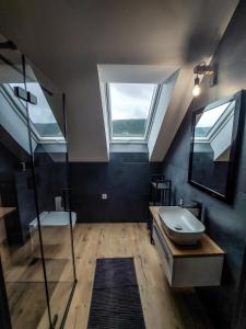 a large bathroom with a sink and a window at Domek Veron in Wysowa-Zdrój