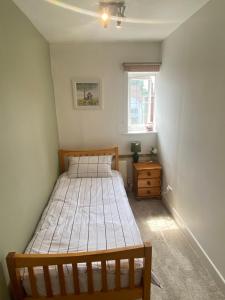 a bedroom with two beds and a window at Spacious single and double bedroom in Southampton with free parking in Southampton