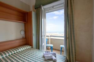 Posteľ alebo postele v izbe v ubytovaní Hotel Adriatica sul Mare