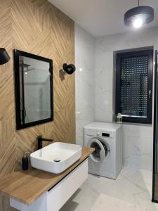 a bathroom with a sink and a washing machine at Domek Veron in Wysowa-Zdrój +23 photos