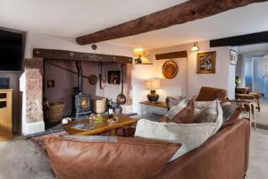 a living room with a couch and a table at The Snuggery a Cosy Country Cottage in Wellington