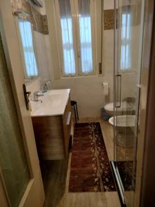 a bathroom with a sink and a shower at S'Agapò in Torre del Greco +16 photos