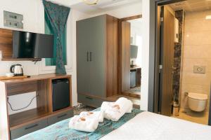 a hotel room with a bed with towels on it at Lotus City Sığacık in Seferihisar