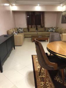 a living room with a couch and a table at view apartments larache in Larache