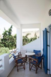 uma varanda com uma mesa e cadeiras e uma vista em Ο Μήλας em Agios Dimitrios