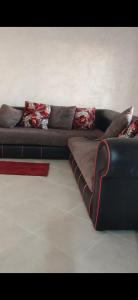 a couch with pillows on it in a living room at Isila blanca in Sidi Bouzid