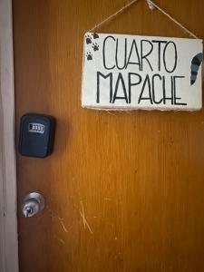 a sign on a door that reads quarto marquez at Greenpointholbox in Holbox Island