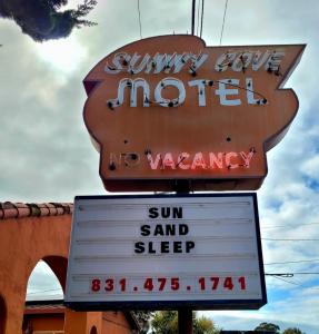 a sign for aasy motel with a sun and sleep sign at Sunny Cove Motel in Santa Cruz