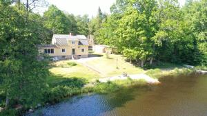 an aerial view of a house next to a river at Holiday Home Småland Paradiset in Ryd
