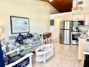 a living room with a couch and a kitchen at Matecumbe Resort in Islamorada