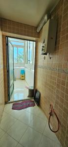 a tiled bathroom with a shower and a window at Residence L'ermitage One bedroom apartment in Mohammedia