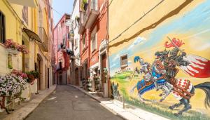 an alley with a painting on the side of a building at B&B Eraclio in Barletta