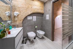 a bathroom with a toilet and a sink and a shower at B&B Eraclio in Barletta