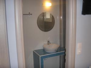 a bathroom with a sink and a mirror at Katerina Lefkada in Vasiliki
