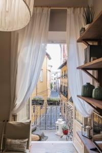 a view of a balcony with a window with curtains at Stence Apartment in Lucca