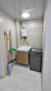 a bathroom with a sink and a trash can at Edificio GrandSky in Cali