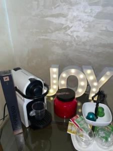 a table topped with a coffee maker and a word love at Villa ain soltan in Imouzzer du Kandar