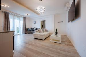 a living room with a white couch and a table at Home Sweet Home in Bologna