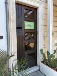 a door to a restaurant with a sign on it at B&B Martius 2 in Martano