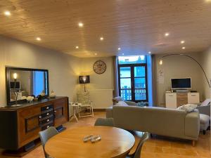 a living room with a couch and a table at Le petit Luxembourg in Valleraugue +8 photos