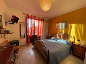 sypialnia z łóżkiem, biurkiem i oknem w obiekcie B&B Martius 2 w mieście Martano