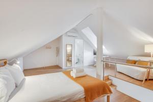 a white bedroom with a bed and a desk at Hygge Chiado in Lisbon