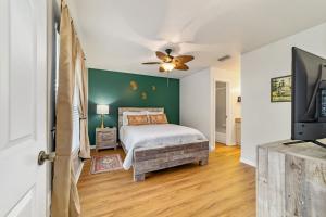 a bedroom with a bed and a flat screen tv at THE GOLDEN PONY-Newly Renovated, 8min to WEC, Pet Friendly in Ocala