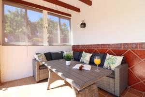 a patio with a wooden table and chairs at Villa los Tablazos SpainSunRentals 1009 in Frigiliana