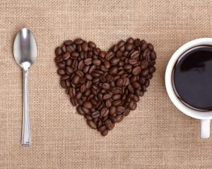 un corazón hecho de granos de café junto a una taza de café en Lulu Pousada Buzios, en Búzios