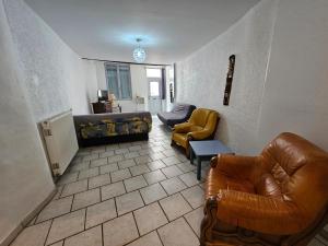 uma sala de estar com cadeiras de couro e um sofá em Gîte chez Effat em Saint-Aignan