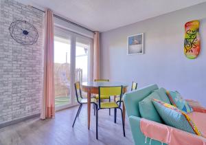 a dining room with a table and a chair at Oasis d'Exception avec Terrasse Privée & Piscine ! in Evry-Courcouronnes