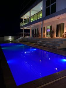 a swimming pool in front of a house at night at Vilamar in Tibau do Sul