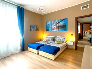 a bedroom with a bed with blue pillows at Rho Fiera Milano Apartment in Pero
