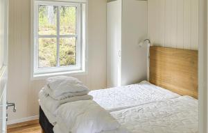 a white bedroom with a bed with a window at Awesome Apartment In Slen With Wifi in Stöten