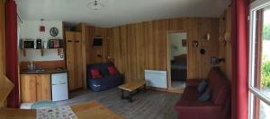 a living room with a couch and a table at Gîte Baden in Le Boulvé
