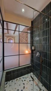 a glass shower door in a bathroom with at Bujtina Behram in Korçë