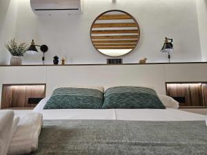 a bedroom with a large bed with a mirror on the wall at El Rincón de Mariela By Travel Home in Segura de la Sierra