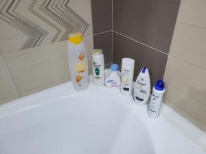 a group of toiletries sitting on a tub in a bathroom at Subcetate Residence in Bistriţa