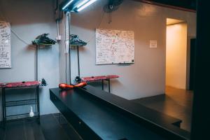 a room with a table with a baseball bat on it at Bed Attitude Hostel Cenang in Pantai Cenang