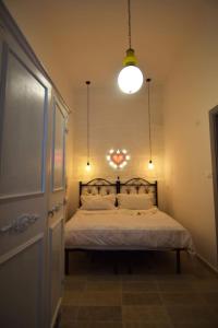 a bedroom with a bed and a light and a door at Una Biancasa in Carovigno +96 photos