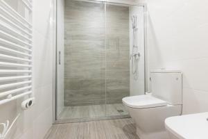 a white bathroom with a shower and a toilet at RNET - Madrid 33 - Roses Costa Brava in Roses