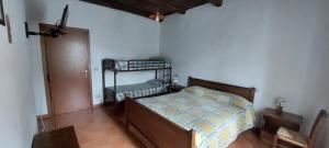 a bedroom with a bed and two bunk beds at Agriturismo Macchiapiede in Sala Consilina