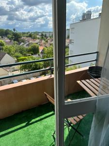 a balcony with a view of the city at Studio cosy in Le Mée-sur-Seine