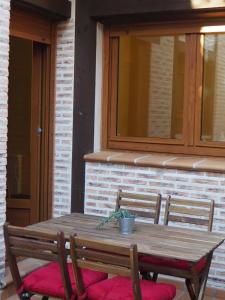 una mesa de madera con una maceta en un patio en Casa Jacaranda, en Arenas de San Pedro