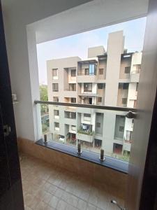 Blick auf ein großes Gebäude aus dem Fenster in der Unterkunft Ornate Service Apartments in Pune