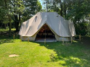 a tent in a field in the grass at Superior Luxury Large Emperor Tent in Stoke Goldington